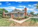 View of the property showcasing the brick facade, landscaping, and chimney at 4622 Ludwell Branch Ct, Raleigh, NC 27612