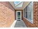 Inviting front porch with brick walls and windows at 4622 Ludwell Branch Ct, Raleigh, NC 27612