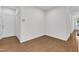 Hallway featuring hardwood floors, neutral walls, and access to multiple rooms at 4622 Ludwell Branch Ct, Raleigh, NC 27612