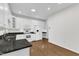 Modern kitchen features white cabinetry, granite countertops, and stainless-steel appliances at 4622 Ludwell Branch Ct, Raleigh, NC 27612