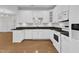 Bright kitchen with white cabinets, black countertops, and stainless-steel appliances at 4622 Ludwell Branch Ct, Raleigh, NC 27612