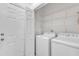 This laundry room has a washing machine, dryer, and shelving at 4622 Ludwell Branch Ct, Raleigh, NC 27612