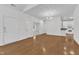 Bright living room with hardwood floors, white walls, and an open floor plan flowing into the kitchen at 4622 Ludwell Branch Ct, Raleigh, NC 27612