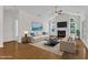 Bright living room featuring hardwood floors, a fireplace, and natural light at 4622 Ludwell Branch Ct, Raleigh, NC 27612