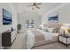 Stylishly staged bedroom with neutral colors, ceiling fan, and many pillows at 4622 Ludwell Branch Ct, Raleigh, NC 27612