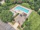 Aerial view of a pool surrounded by lush trees and seating at 4622 Ludwell Branch Ct, Raleigh, NC 27612