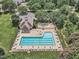 Aerial view of large pool, lounge seating, and lush landscaping at 4622 Ludwell Branch Ct, Raleigh, NC 27612