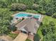 Aerial view of community pool featuring a large swimming area, seating, and landscaping at 4622 Ludwell Branch Ct, Raleigh, NC 27612
