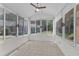 Bright sunroom with tiled flooring, large windows, and a ceiling fan at 4622 Ludwell Branch Ct, Raleigh, NC 27612