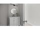 Bathroom featuring a white vanity, marble countertop, a round mirror, and modern lighting at 505 Hawfields Rd, Mebane, NC 27302