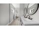 Bathroom featuring double vanity, modern fixtures, and a glimpse into the bedroom at 505 Hawfields Rd, Mebane, NC 27302
