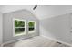 Bedroom featuring two large windows offering natural light and pleasant outdoor views at 505 Hawfields Rd, Mebane, NC 27302
