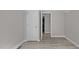 Well-lit bedroom with light wood floors and open doorway to a connected room at 505 Hawfields Rd, Mebane, NC 27302
