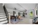 Open concept space with dining table, kitchen, and staircase in a naturally lit room at 505 Hawfields Rd, Mebane, NC 27302
