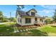 Exterior view of a house with white siding, black trim, metal roof and a stepping stone walkway at 505 Hawfields Rd, Mebane, NC 27302