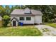 Charming home exterior with black roof, white siding, a shed and a gravel driveway at 505 Hawfields Rd, Mebane, NC 27302