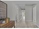 Hallway with light gray walls, modern light-colored flooring, and decorative wall art at 505 Hawfields Rd, Mebane, NC 27302