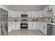 Modern kitchen featuring stainless steel appliances, white cabinets, and light countertops at 505 Hawfields Rd, Mebane, NC 27302