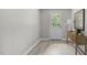 A serene room with light gray walls, modern flooring, a side table and a door to the exterior at 505 Hawfields Rd, Mebane, NC 27302