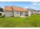 Spacious backyard featuring a grassy lawn and a back door leading to the house at 5104 Parkerwood Dr, Knightdale, NC 27545