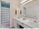 Well-lit bathroom featuring a double vanity, ample countertop space, and a shower-tub combination at 5104 Parkerwood Dr, Knightdale, NC 27545