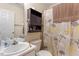 Bathroom with vanity, toilet and shower with daisy patterned curtain at 5104 Parkerwood Dr, Knightdale, NC 27545