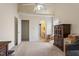 Large bedroom featuring high ceilings, neutral decor, and doorway to ensuite bathroom at 5104 Parkerwood Dr, Knightdale, NC 27545