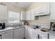 Efficient kitchen featuring essential appliances, ample cabinet space, and bright natural lighting at 5104 Parkerwood Dr, Knightdale, NC 27545