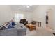 Bright living room with plush seating, neutral colors, and natural light, creating a comfortable living space at 5104 Parkerwood Dr, Knightdale, NC 27545