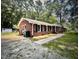 One-story brick home with a driveway, walkway, and lots of trees in the background at 512 Crestview Dr, Durham, NC 27712