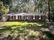 Charming one-story brick home with a well-maintained lawn and beautiful, mature trees at 512 Crestview Dr, Durham, NC 27712