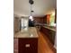 Bright kitchen with wood cabinets, granite counters, stainless appliances, and hardwood floors at 512 Crestview Dr, Durham, NC 27712