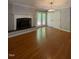 Cozy living area with hardwood flooring, fireplace, and access to a private outdoor space at 512 Crestview Dr, Durham, NC 27712