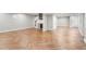 Open basement with herringbone floors, a bar area, and a staircase at 5509 Cliffwood Ct, Raleigh, NC 27609