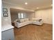 Spacious basement featuring a stylish L shaped couch and herringbone flooring at 5509 Cliffwood Ct, Raleigh, NC 27609