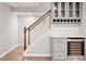Basement staircase with modern wine storage and bar area at 5509 Cliffwood Ct, Raleigh, NC 27609