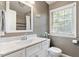 Well-lit bathroom featuring a single sink vanity with a white countertop and a framed mirror at 5509 Cliffwood Ct, Raleigh, NC 27609