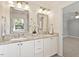 Bathroom featuring double sinks, granite counters, and decorative mirrors for a spa-like experience at 5509 Cliffwood Ct, Raleigh, NC 27609