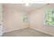 Bright bedroom featuring a light paint, neutral carpet, and two windows at 5509 Cliffwood Ct, Raleigh, NC 27609