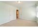 Spacious bedroom with neutral carpet, closet, and attached bathroom at 5509 Cliffwood Ct, Raleigh, NC 27609