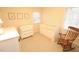 Cozy bedroom with white crib, rocking chair, and natural light at 5509 Cliffwood Ct, Raleigh, NC 27609