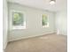 Bright bedroom featuring two windows and neutral carpet at 5509 Cliffwood Ct, Raleigh, NC 27609