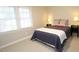 Bedroom with comfortable bed and natural light from large windows at 5509 Cliffwood Ct, Raleigh, NC 27609