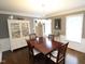 Formal dining room with dark wood table, china cabinet and neutral-toned walls at 5509 Cliffwood Ct, Raleigh, NC 27609