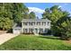 Attractive two-story brick home with meticulously maintained lawn, classic black shutters, and a vibrant blue entrance door at 5509 Cliffwood Ct, Raleigh, NC 27609