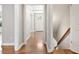 Hallway with hardwood floors leading to the front door and staircase at 5509 Cliffwood Ct, Raleigh, NC 27609