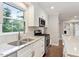Bright kitchen features a stainless steel range and sink with granite countertops at 5509 Cliffwood Ct, Raleigh, NC 27609