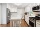 Beautiful kitchen with stainless steel appliances, custom cabinets, and a central island at 5509 Cliffwood Ct, Raleigh, NC 27609