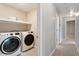 Modern laundry room with stainless steel washer and dryer at 5509 Cliffwood Ct, Raleigh, NC 27609