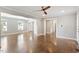 Open concept living room with hardwood floors and multiple windows for natural light at 5509 Cliffwood Ct, Raleigh, NC 27609
